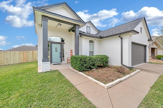 view of front of house with a garage and a front yard