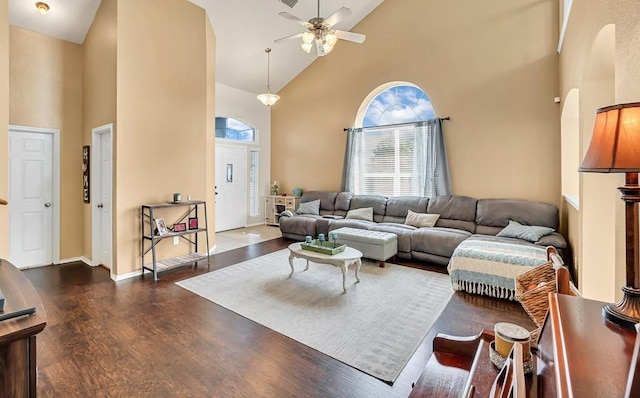 living room featuring ceiling fan, high vaulted ceiling, and dark hardwood / wood-style floors