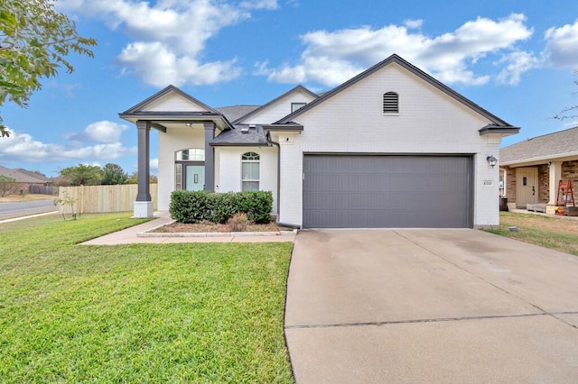 view of front facade with a front yard and a garage