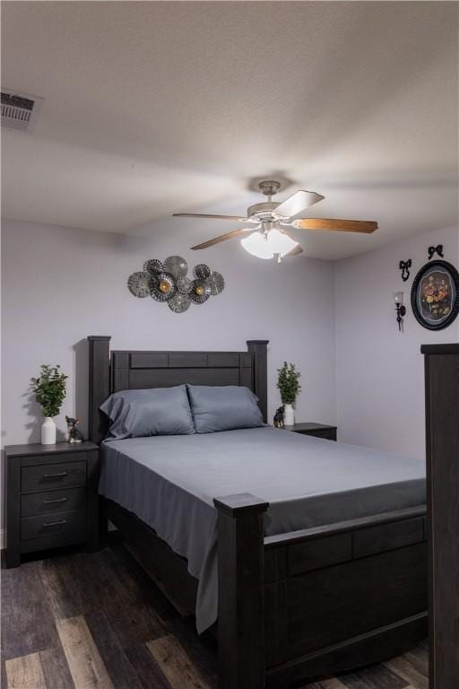 bedroom with ceiling fan and dark wood-type flooring