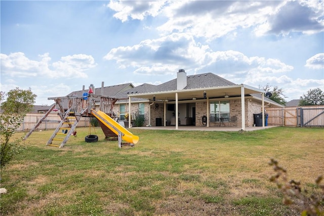 back of property featuring a patio, a playground, ceiling fan, and a lawn