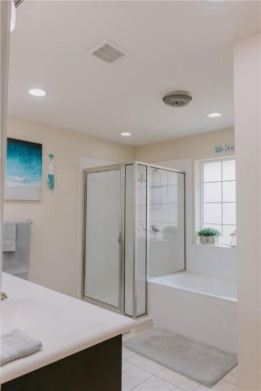 bathroom featuring tile patterned floors, plus walk in shower, and vanity