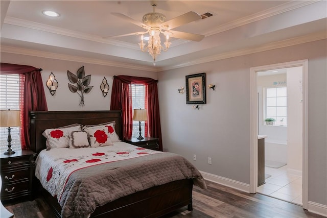 bedroom with ensuite bath, ceiling fan, crown molding, and wood-type flooring