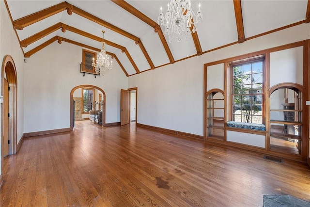 unfurnished living room with beamed ceiling, high vaulted ceiling, a chandelier, and hardwood / wood-style floors