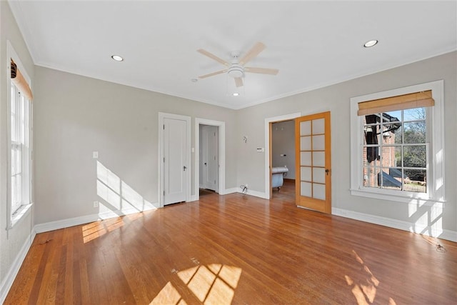 spare room with wood-type flooring, ornamental molding, and ceiling fan