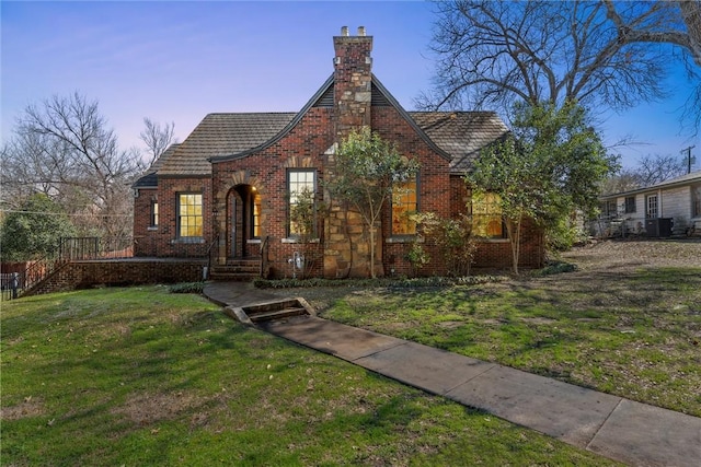 tudor-style house with a yard