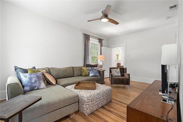 living room featuring wood-type flooring and ceiling fan