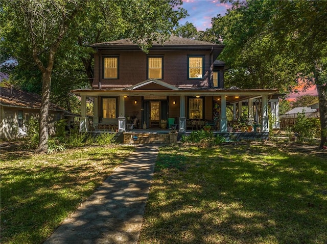 view of front facade featuring a lawn and a porch