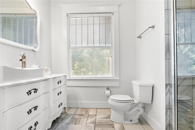 bathroom with vanity, toilet, and an enclosed shower