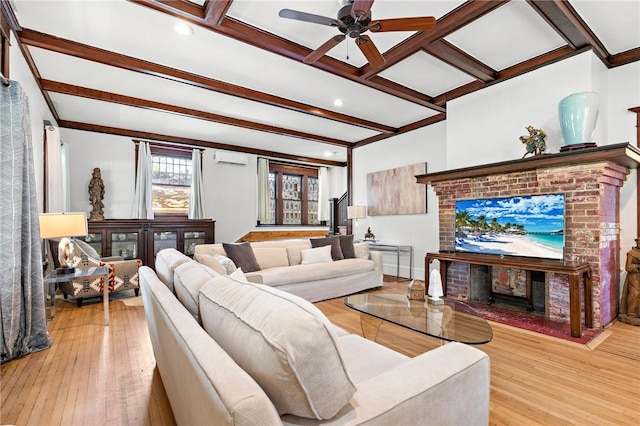 living room with beam ceiling, ceiling fan, coffered ceiling, a wall mounted air conditioner, and light wood-type flooring