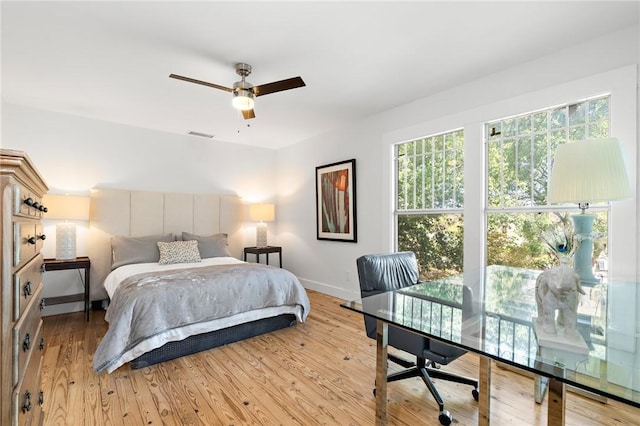 bedroom with ceiling fan and light wood-type flooring