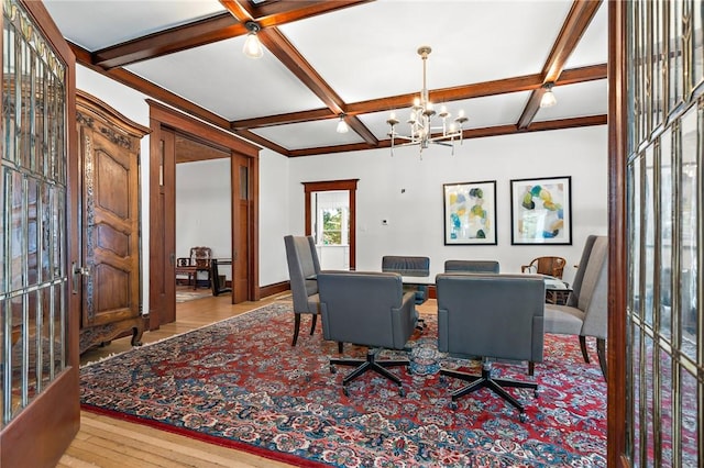 dining space featuring an inviting chandelier, light wood-type flooring, beam ceiling, and coffered ceiling