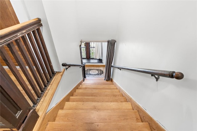 stairway featuring wood-type flooring