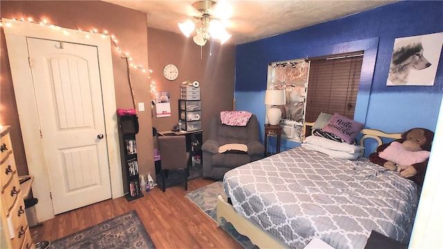 bedroom featuring hardwood / wood-style floors and ceiling fan