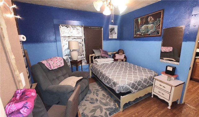 bedroom with ceiling fan and wood-type flooring