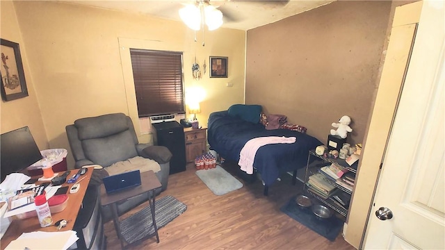 bedroom with hardwood / wood-style flooring and ceiling fan