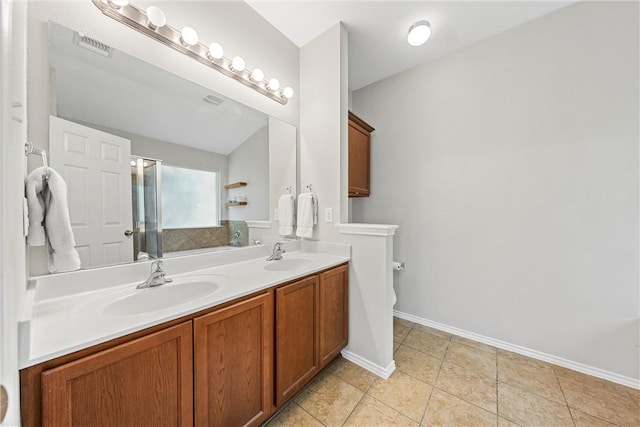 bathroom featuring tile patterned floors, vanity, toilet, and a shower