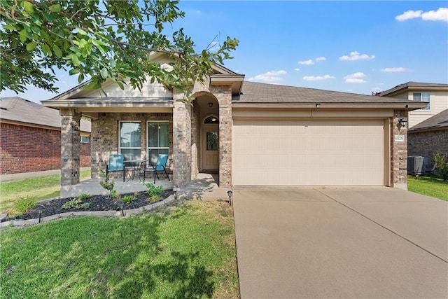 view of front of house with a porch, a garage, a front yard, and central AC