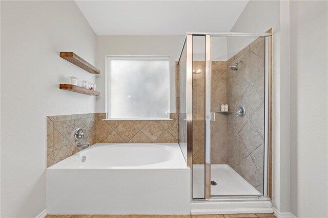 bathroom featuring separate shower and tub and lofted ceiling