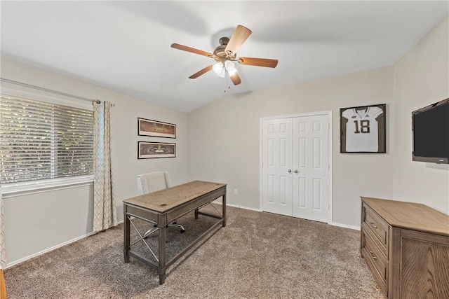 carpeted office space with ceiling fan and lofted ceiling