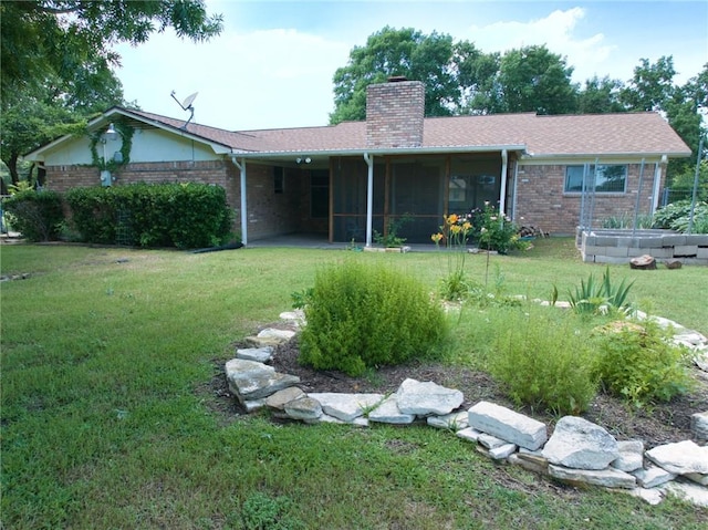 view of front facade featuring a sunroom and a front lawn