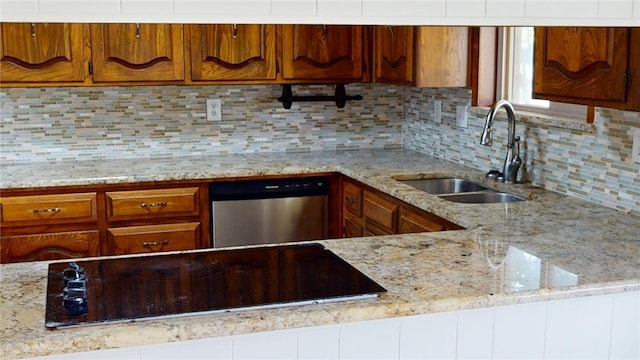 kitchen featuring dishwasher, sink, decorative backsplash, light stone counters, and black electric cooktop