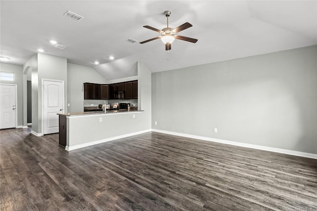 unfurnished living room with ceiling fan, sink, dark hardwood / wood-style flooring, and vaulted ceiling