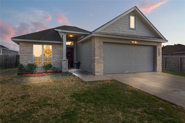 view of front of property featuring a yard and a garage