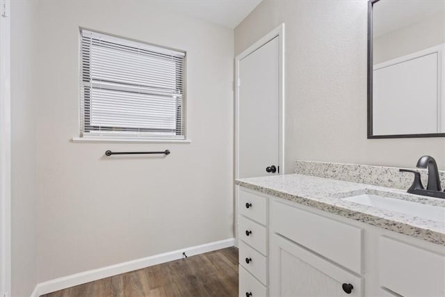 bathroom with hardwood / wood-style flooring and vanity