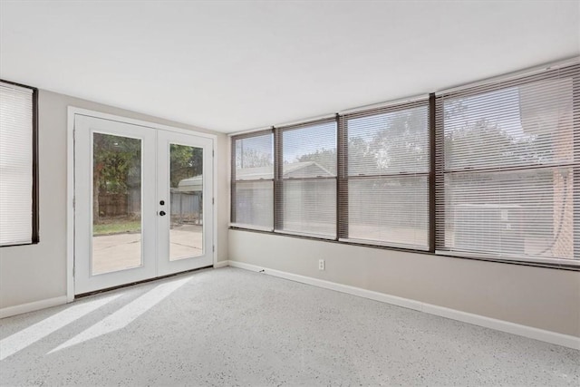 unfurnished sunroom featuring french doors