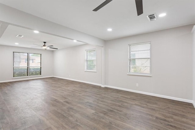 spare room featuring ceiling fan and dark hardwood / wood-style flooring