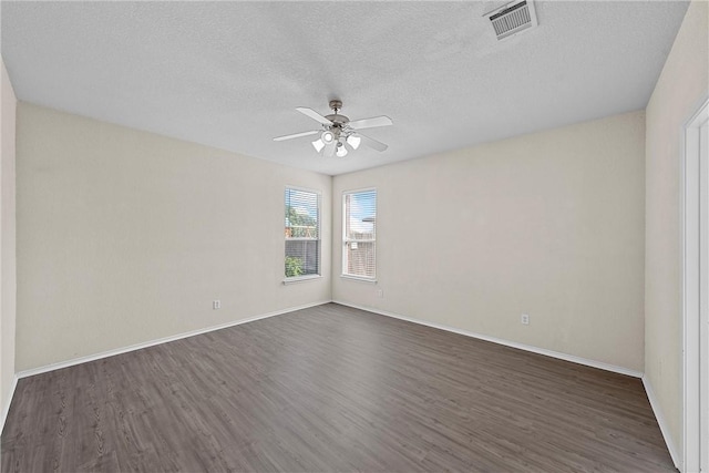 unfurnished room with dark hardwood / wood-style floors, ceiling fan, and a textured ceiling