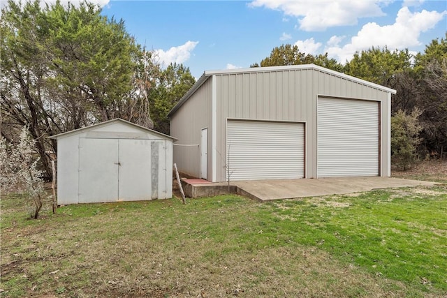 detached garage featuring a storage shed