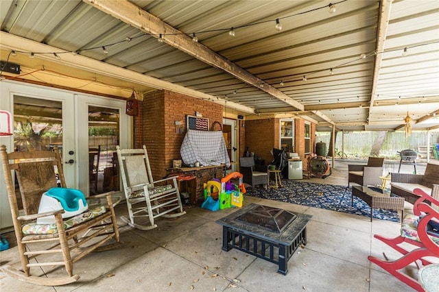 view of patio / terrace with an outdoor living space with a fire pit and french doors