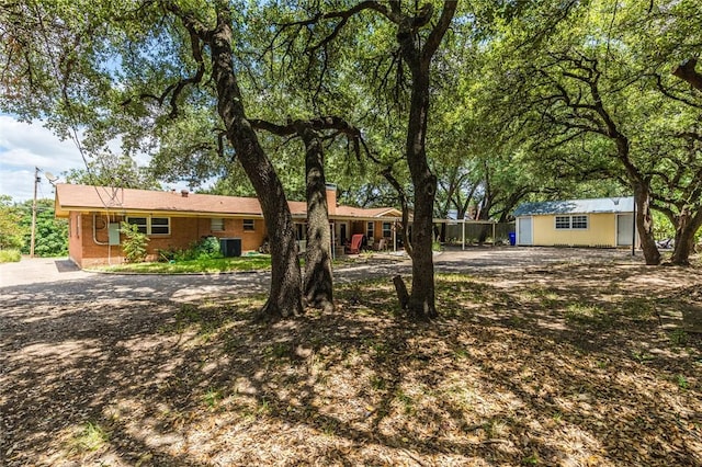 ranch-style house featuring an outbuilding