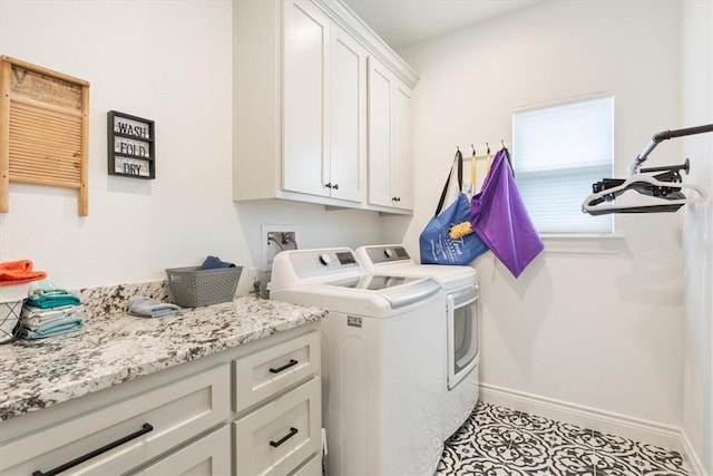 laundry area with cabinet space, washing machine and dryer, baseboards, and light tile patterned flooring