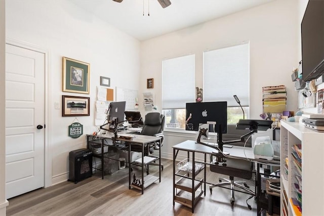 office area with baseboards, a ceiling fan, and wood finished floors