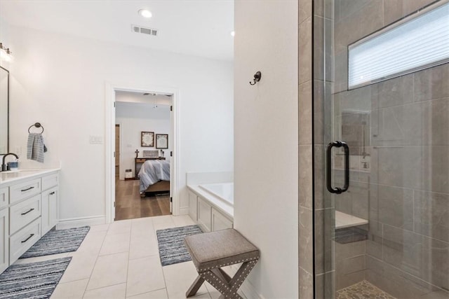 ensuite bathroom featuring connected bathroom, vanity, visible vents, a shower stall, and tile patterned floors