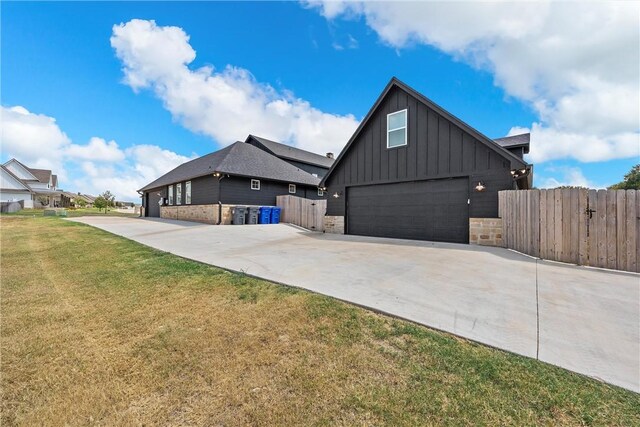 view of front of property featuring a garage and a front lawn