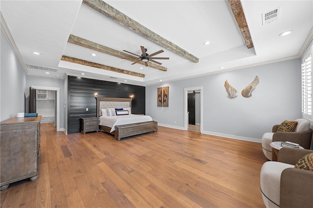 bedroom featuring ceiling fan, light wood-type flooring, and a raised ceiling