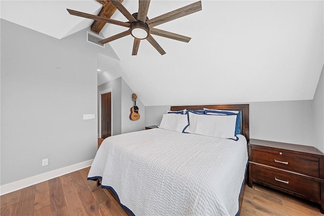 bedroom featuring vaulted ceiling, ceiling fan, and light wood-type flooring