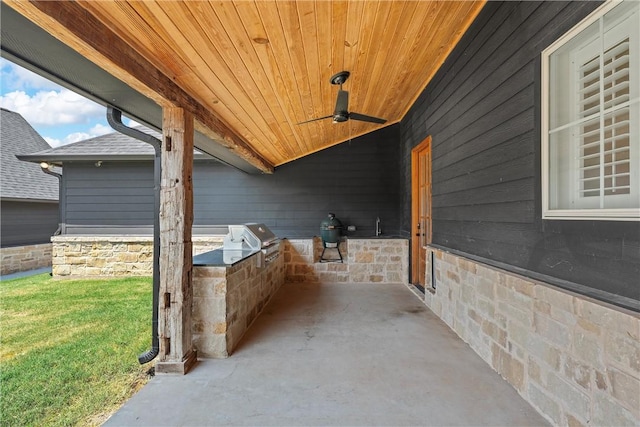 view of patio / terrace with ceiling fan, a grill, and an outdoor kitchen