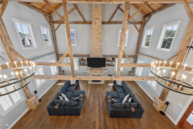 exercise area featuring high vaulted ceiling, wood ceiling, a chandelier, and hardwood / wood-style flooring