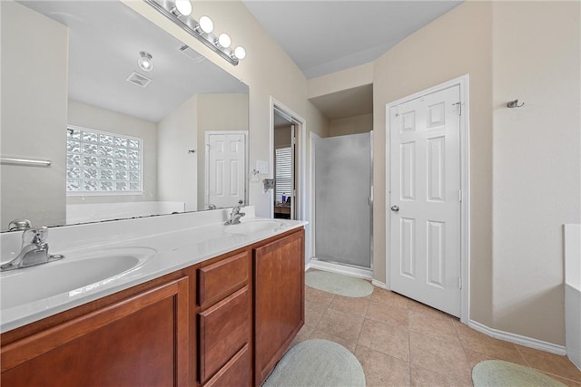 bathroom with tile patterned floors, vanity, and a shower with shower door