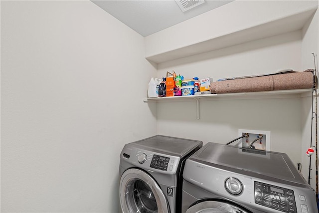 laundry room featuring washer and clothes dryer