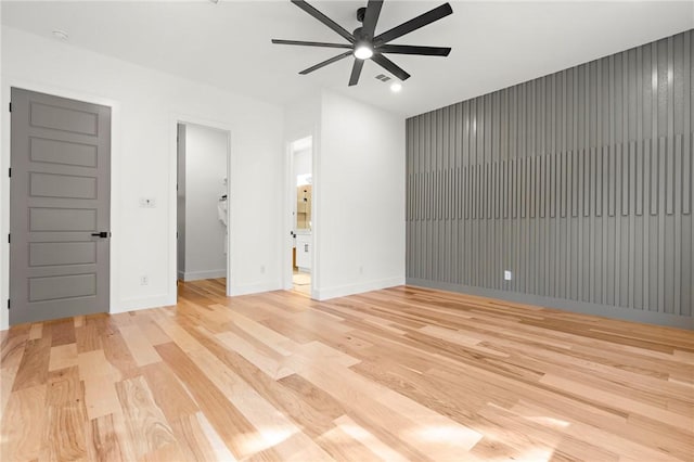 spare room featuring ceiling fan and light hardwood / wood-style floors