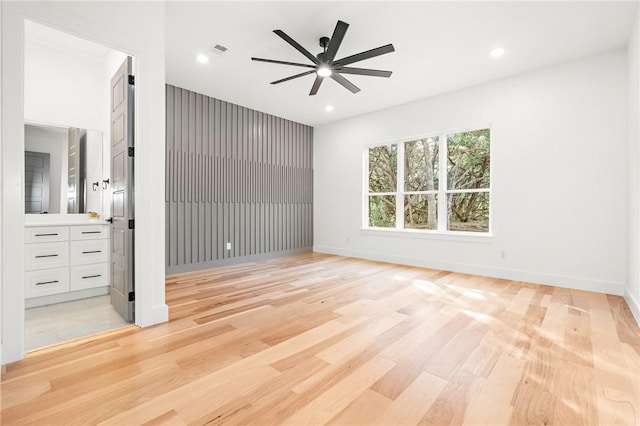 unfurnished bedroom featuring ceiling fan and light wood-type flooring