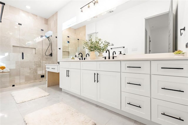 bathroom with vanity and a shower with shower door