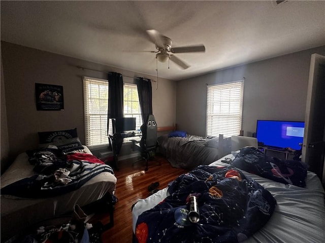 bedroom with ceiling fan and hardwood / wood-style floors