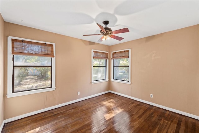 empty room featuring wood-type flooring, plenty of natural light, and ceiling fan